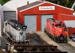 NJT 4112 and M&E 23 sit outside the shops 